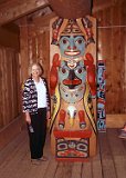 Alaska Trip - Anchorage - Alaska Native Heritage Center - Eyak, Tlingit, Haida and Tsimshian Village Site Northern Tlingit Short Frontal Totem Pole - This is a picture of Lucinda in the same village site by a northern Tlingit frontal totem pole. Living in the north were the trees did not grow so tall, their totem poles were much shorter and occasionally placed inside their houses. Alaska Trip - Anchorage - Alaska Native Heritage Center - Eyak, Tlingit, Haida and Tsimshian Village Site Northern Tlingit Short Frontal Totem Pole