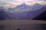 Alaska Trip - Glacier Bay - Johns Hopkins Inlet - Johns Hopkins Glacier from Jaw Point - After spending 2 hours in Tarr Inlet viewing those glaciers, we turned back and entered Johns Hopkins Inlet which has Johns Hopkins Glacier at its head. (Both were named after the university by an alumnus). Harbor Seal pupping activities occur from May through August and they like to use floating ice as "haul outs" for these activities. Since there is extensive floating ice at the terminus of the glacier, cruise boats may not get any closer to the glacier than Jaw Point, about 5 miles away. This picture was taken from that location. The air was quite hazy due to wild fires in western Canada. The resulting pictures were not as good as might be hoped. This is the best of the pictures and I had to Photoshop it extensively to eliminate the haze. The visible glacier terminus is over 5 miles away. At the left edge the terminus of Gilman Glacier can also be seen. The two glaciers regularly join and separate as they advance and retreat in their separate courses. Despite the haze, this view from Jaw Point was one of the most magnificent sights of the entire vacation. Alaska Trip - Glacier Bay - Johns Hopkins Inlet - Johns Hopkins Glacier from Jaw Point